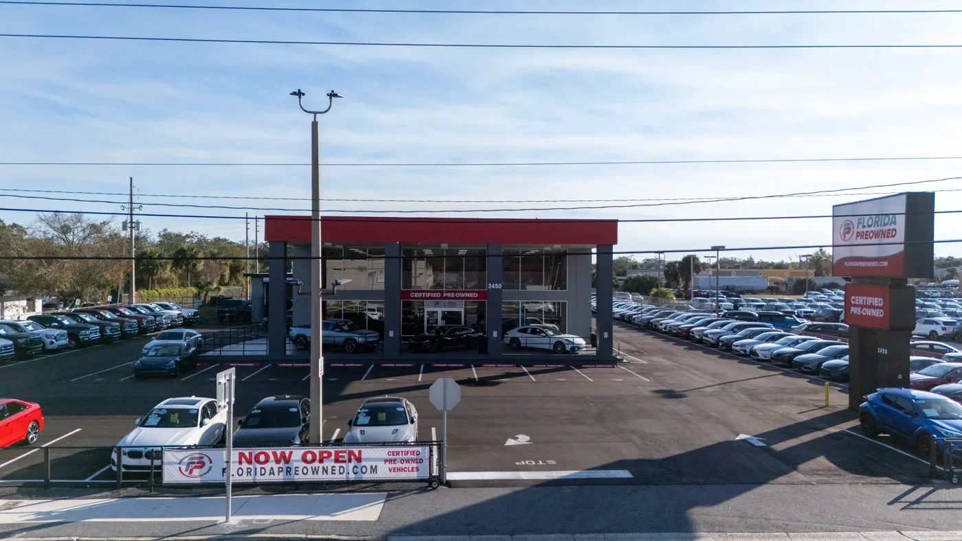 Wide view of the Florida Preowned vehicle lot in Orlando, FL — pre-owned cars and SUVs ready for delivery