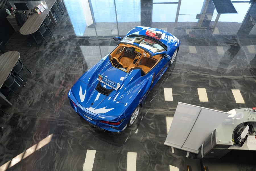 Florida Preowned indoor showroom at 3450 W Colonial Drive, Orlando, FL 32808 — pre-owned Chevrolet Corvette convertible displayed on the polished showroom floor under skylights.
